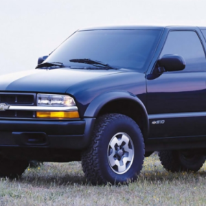 a black suv parked on grass