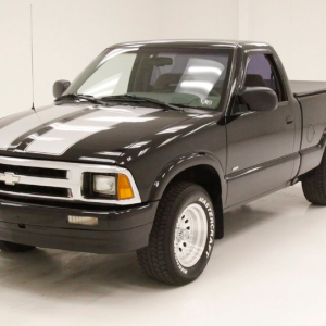 a black truck with white stripes